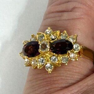 Gold-tone and garnet-colored stone fashion ring.
